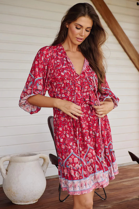 Unleash your inner free spirit in our French Dress - Ruby Rouge Print. The yoked neckline with tie adds a playful touch while the relaxed style and frilled hem provide ultimate comfort. Embrace your creative side with the 3/4 sleeves and matching waist tie, perfect for any occasion. Unlined for a carefree and effortless look.