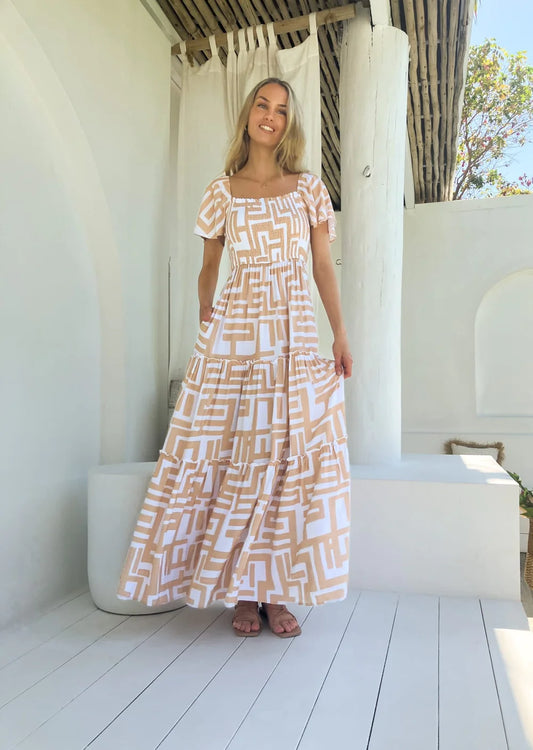 Make a glamorous statement in our Maya Maxi Dress. Crafted with adjustable rouche detail at the bust, this off the shoulder silhouette lends an effortless elegance. The ethereal Geo Print fabric and sweeping maxi length make a timeless and stunning choice.