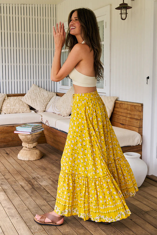 Look chic and stylish with the Opal Maxi Skirt! Exquisite crochet details, intricate button details, and an elastic waistband enhance this luxe piece. The front split and tie up detail adds a bit of edge to this sunshine daisy print skirt. This elegant and sophisticated staple is the perfect addition to any wardrobe.
