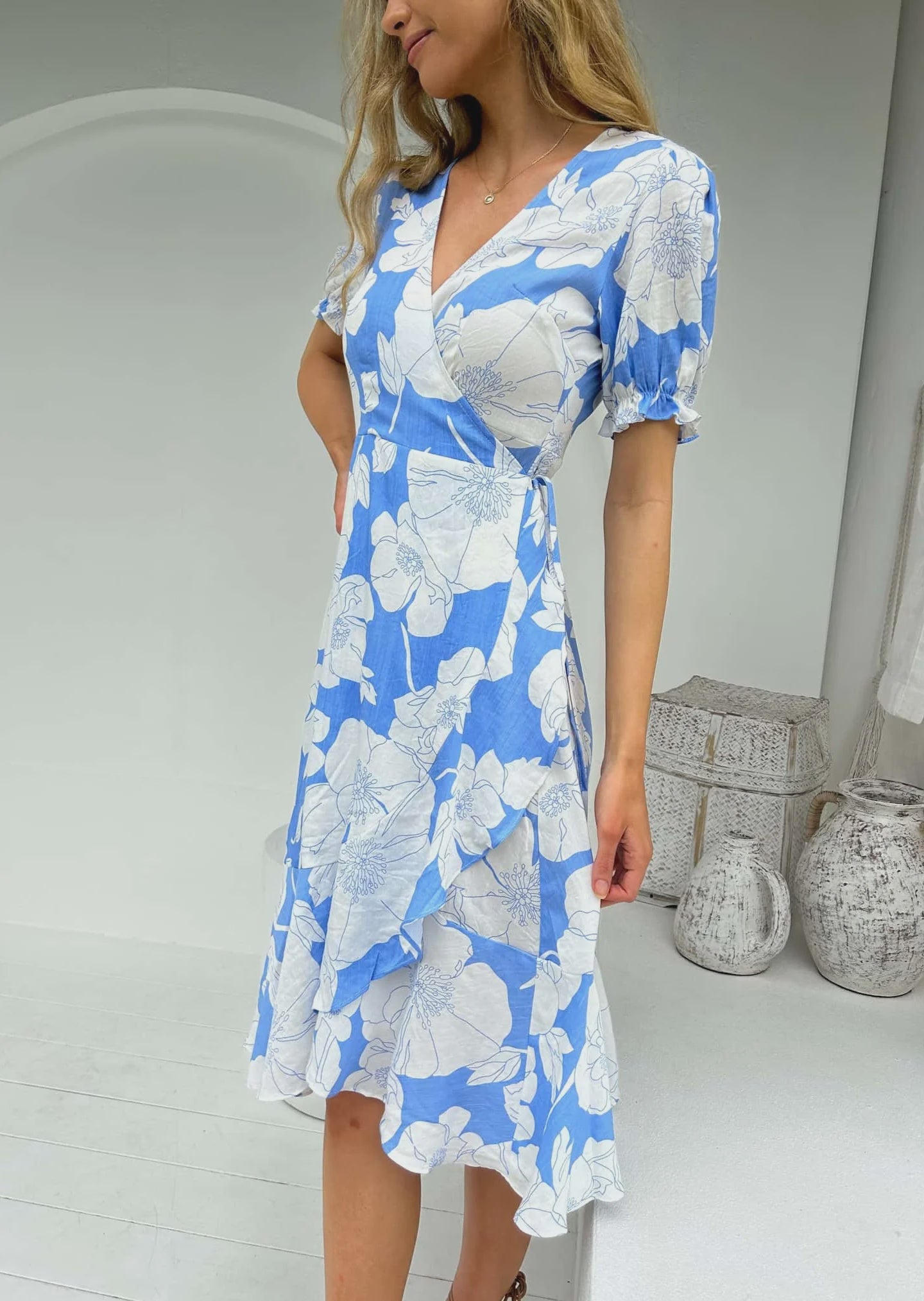  Tailored with a silhouette of timeless elegance, this wrap dress by Angelique is crafted from Ayla print fabric and showcases elasticated capped sleeves, a midi length, and a subtle V neckline. Unparalleled sophistication for an unforgettable statement.