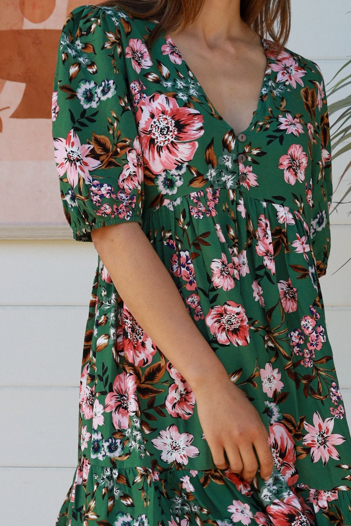 The Daisy Mini Dress is here to bring a bit of sunshine and a lot of chic style to your wardrobe! Featuring a V-neckline, elasticated sleeves, button detail, and a tiered style, this dress is ready to bring some flower power to your summer look!