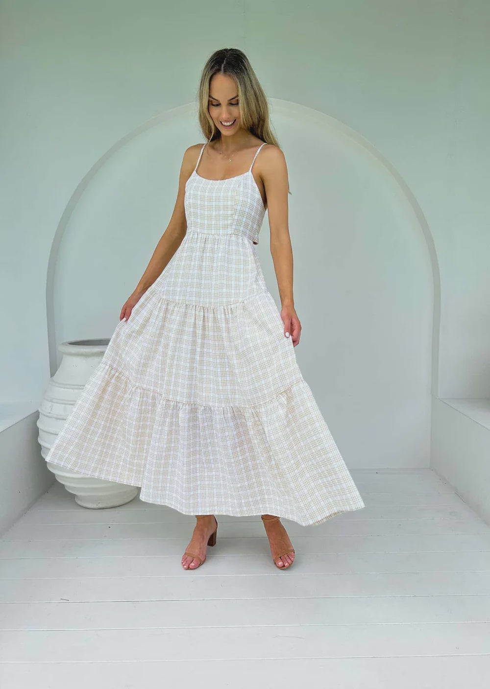 Jump into summer with this Georgie Gingham Maxi Dress! Featuring a tie around detail, spaghetti straps and a low back, this eye-catching dress is guaranteed to turn heads and have you feeling your gingham-ous best!