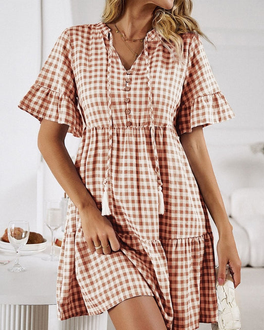 Get ready for an adventure in style with the Lucy Mini Gingham Dress! A fun rust color, and the all-over gingham print make it a must-have for your wardrobe. Not to mention the button detail, draw-up-string, tiered style and cap sleeves give it that extra special something! Ready, set, gingham style!