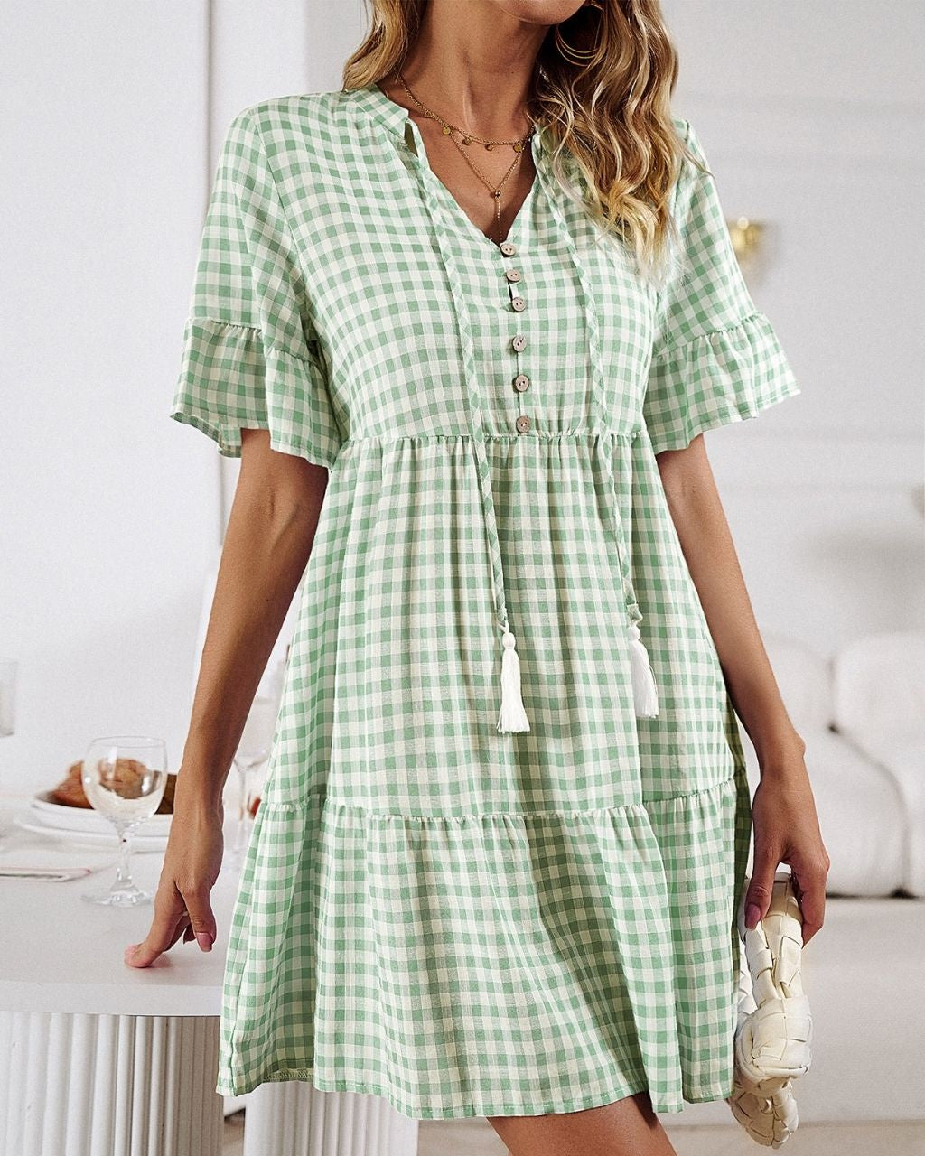 Get ready for an adventure in style with the Lucy Mini Gingham Dress! A fun green color, and the all-over gingham print make it a must-have for your wardrobe. Not to mention the button detail, draw-up-string, tiered style and cap sleeves give it that extra special something! Ready, set, gingham style!