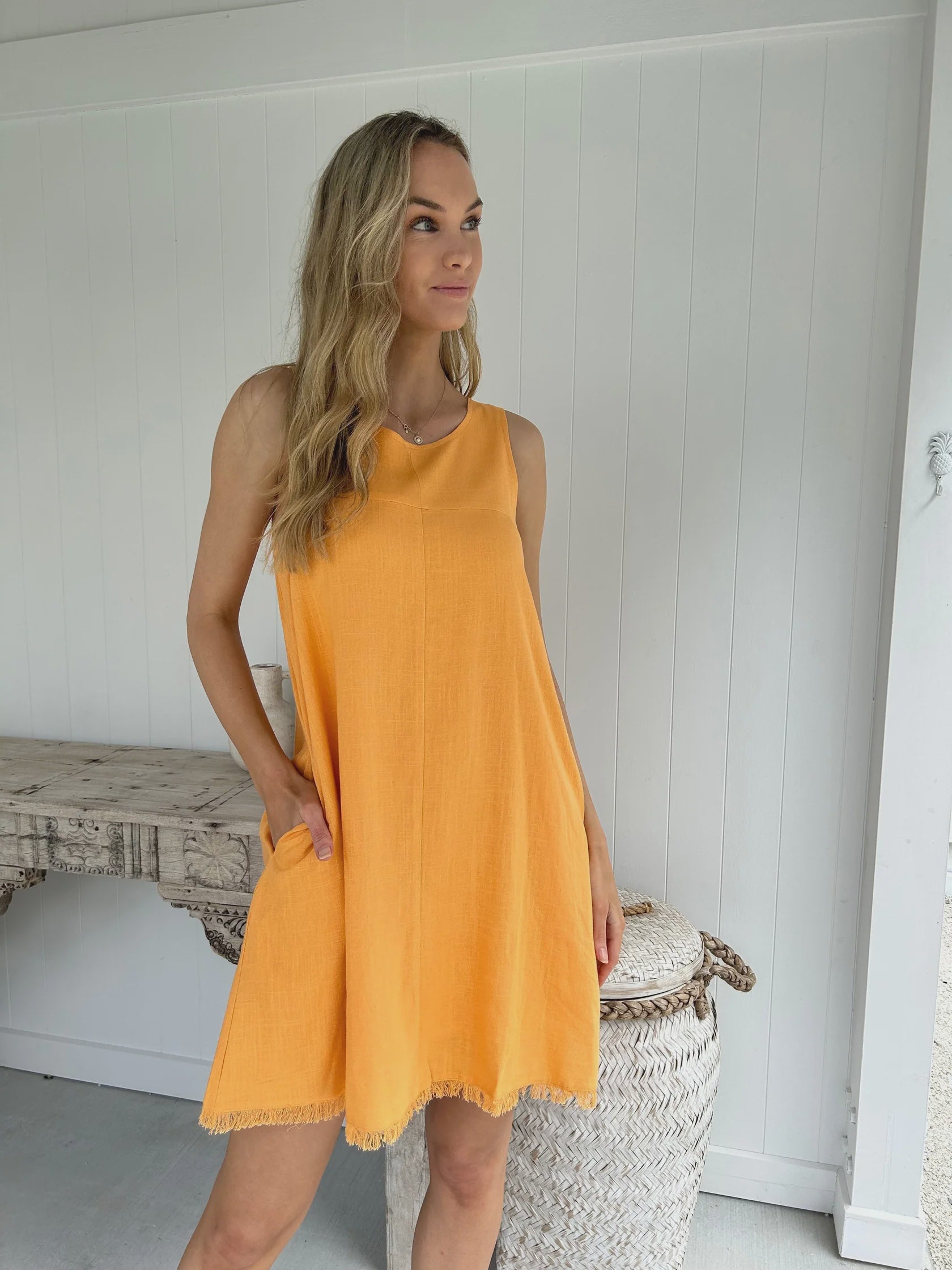 Be inspired by the beauty of nature with this Freya Mini Dress. Featuring a gorgeous earthy orange, a frayed hem, and pockets, this shift fit dress is both stylish and practical. Its lightweight fabric is fully lined to keep you feeling comfortable and looking chic all day long. Perfect for any occasion.