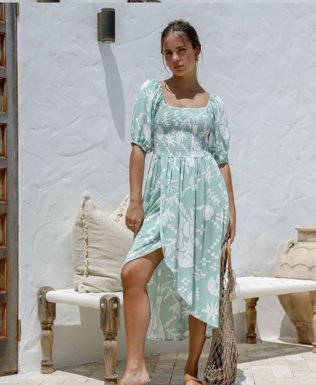 This playful Malta Maxi Dress in Mint Print boasts an off the shoulder design, a sultry slit at the leg, and voluminous balloon sleeves with elasticated cuffs. Perfect for adding a touch of whimsy to your wardrobe! (Slay in style without taking yourself too seriously - it's what we do best!)