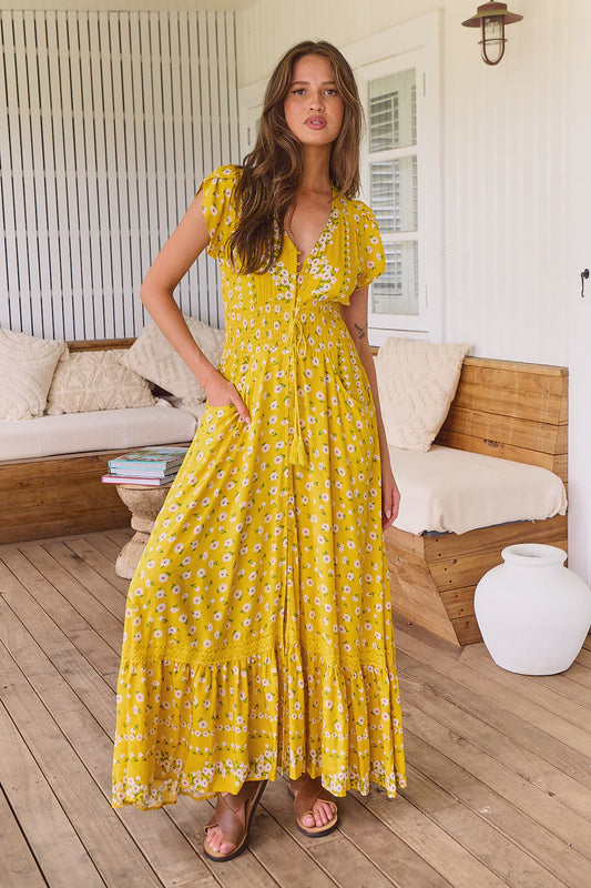 Enjoy sunshine days even more in the Romi Maxi Dress. Crafted from luxuriously smooth fabric, this elegant dress features 3/4 length sleeves, a flattering V neck-line, buttons through the bust, a drawstring at the waist, and a floor-skimming length. The delicate daisy print adds an idyllic touch, making this perfect for any summer gathering.
